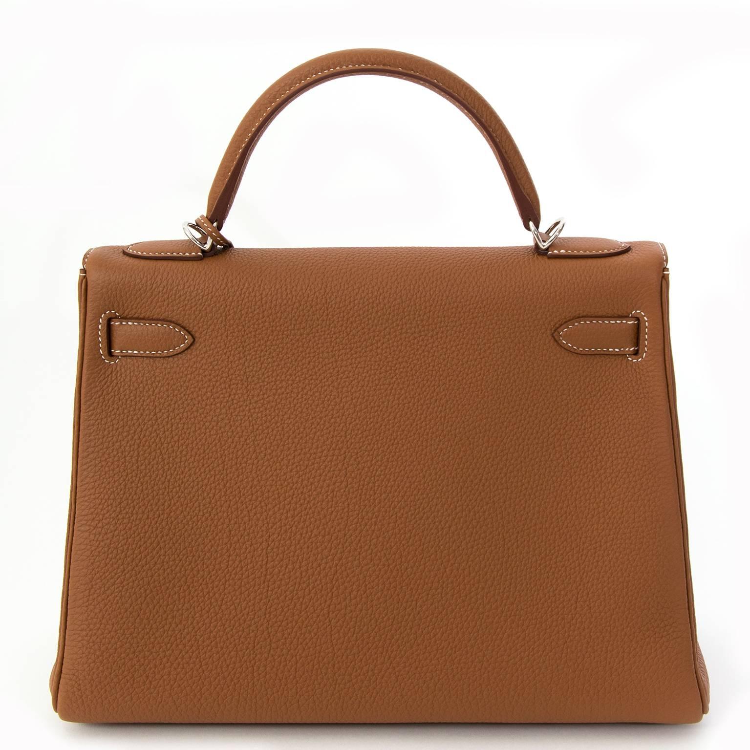 This Hermes Kelly in the iconic Gold color is a real statement piece.
This Kelly bag is made out of the Popular Togo leather. The Kelly bag is accented with palladium hardware and features a single top handle, turn-lock closure, and four protective