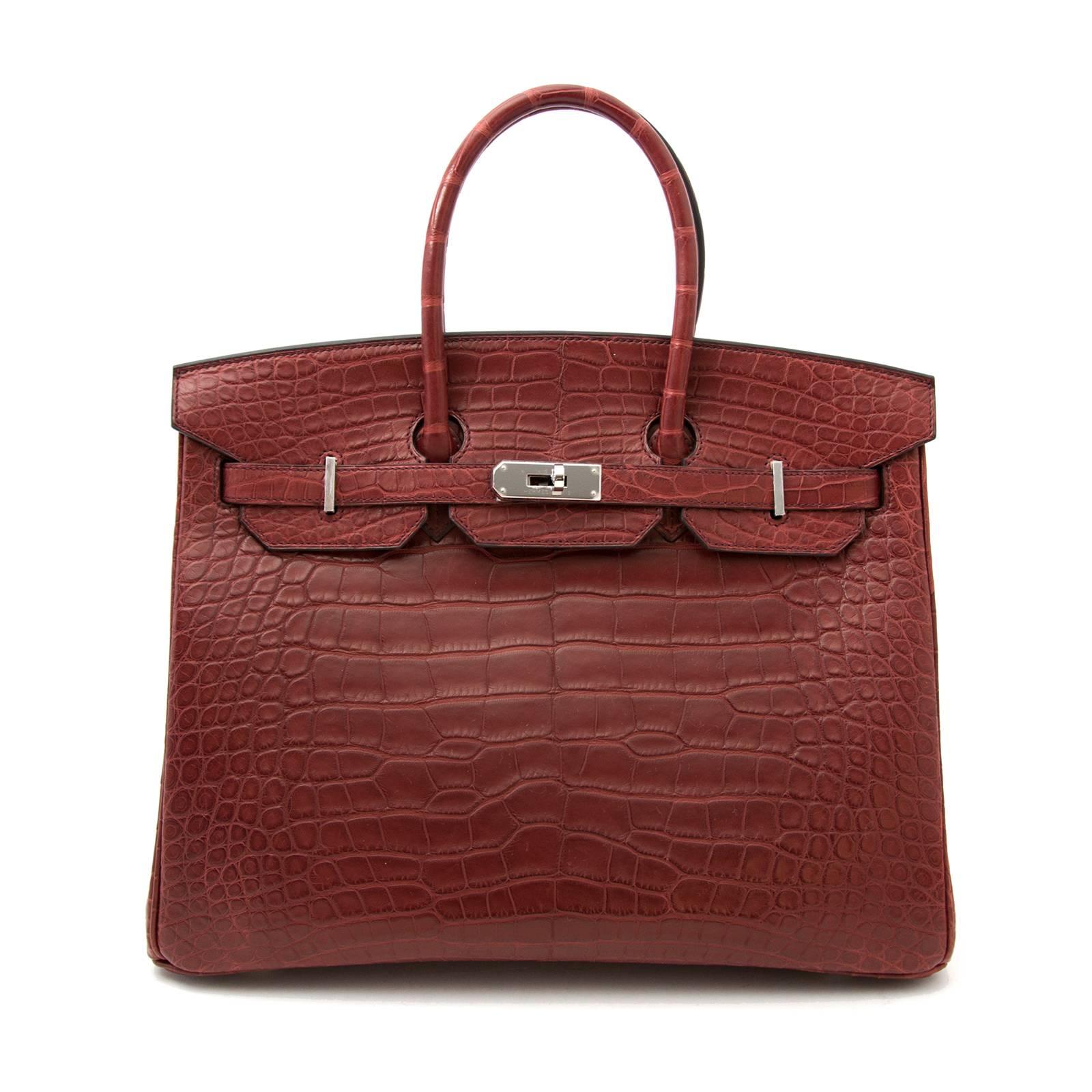 The height of luxury in the form of a bag! Skip the waiting list and get your hands on this extremely rare exotic piece. This gorgeous Hermes Birkin is crafted out of alligator mississippiensis and has a matte finish. The exquisite Bourgogne color