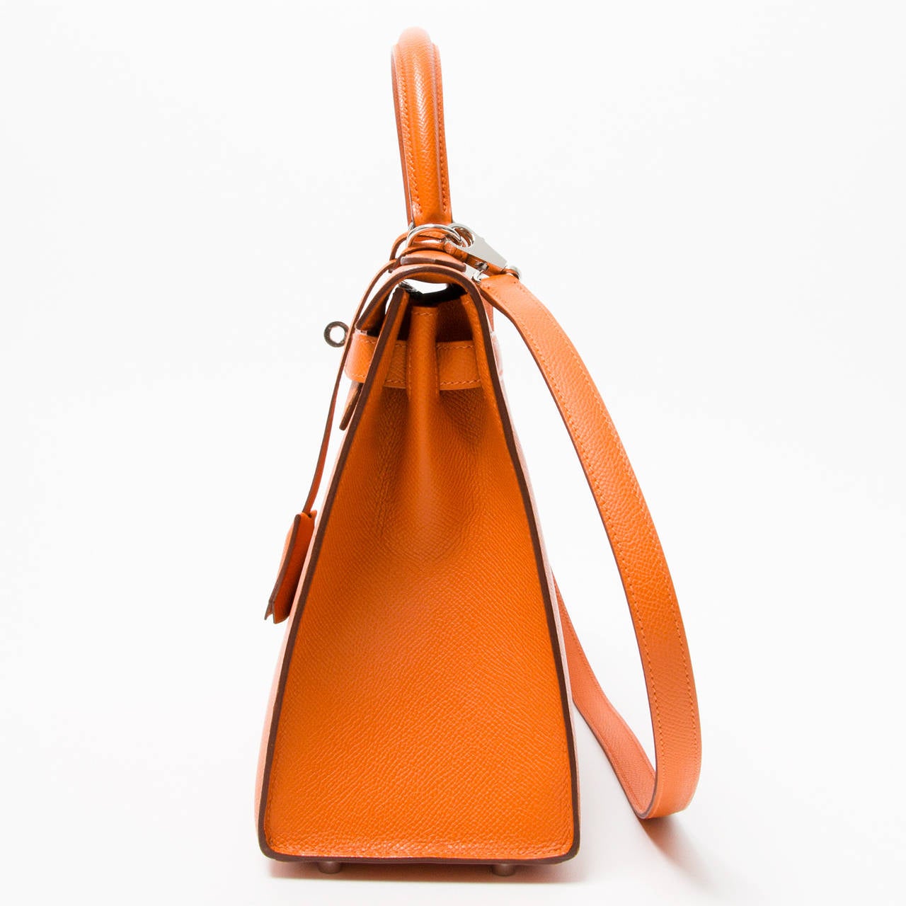 Hermes Orange Kelly 28 in Epsom leather and PHW. 
The compressed type of leather holds true to its shape in all instances and is completely resilient to scratches. With the ‘laminated’ exterior, cleaning an Epsom leather bag is as simple as wiping