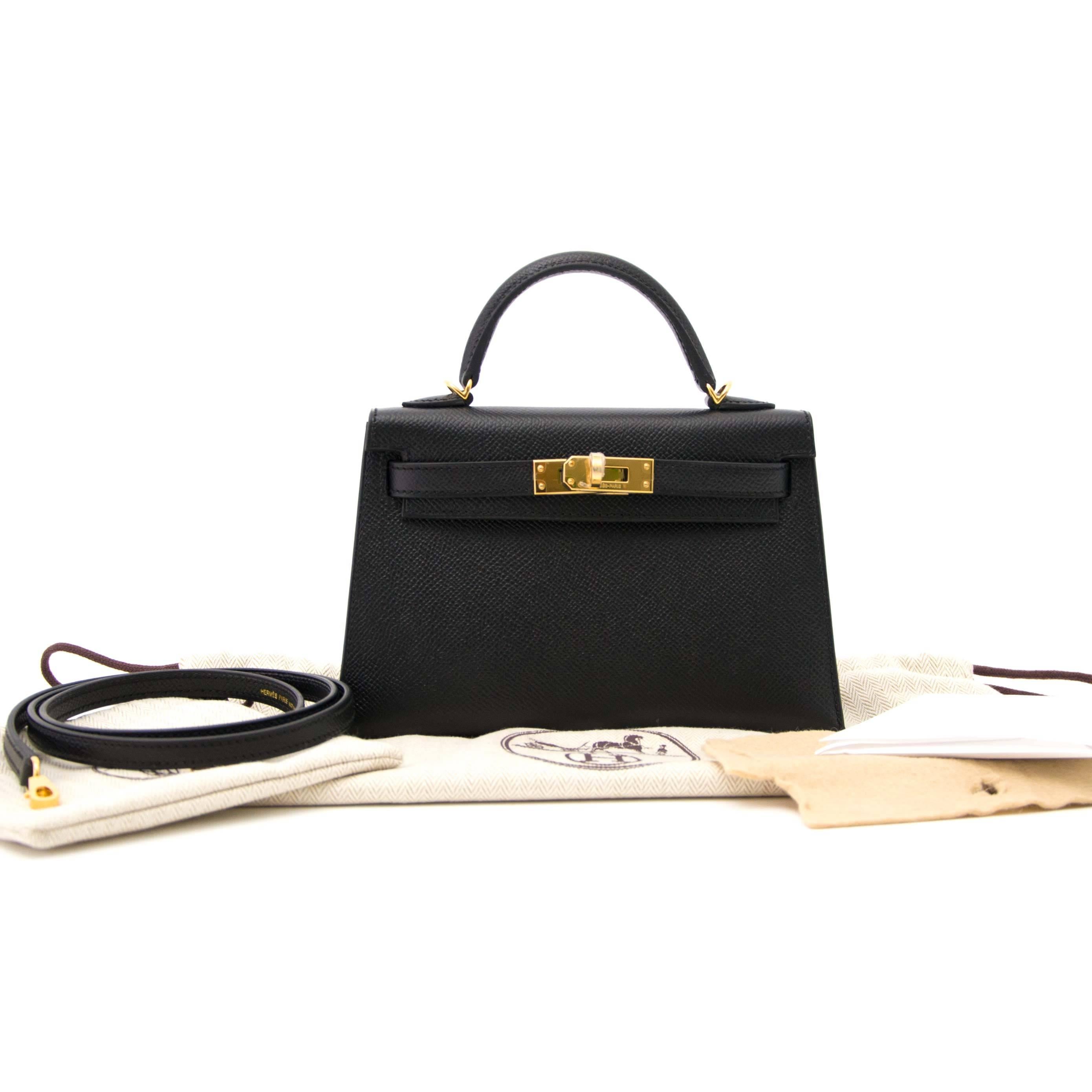 Hermes Mini Kelly Pochette Black Epsom 
This stunning Hermès Mini Kelly Pochette comes in a black epsom leather. 
Epsom is an embossed leather which gives the leather a rigid and structured look that will hold its shape and will show scratching less