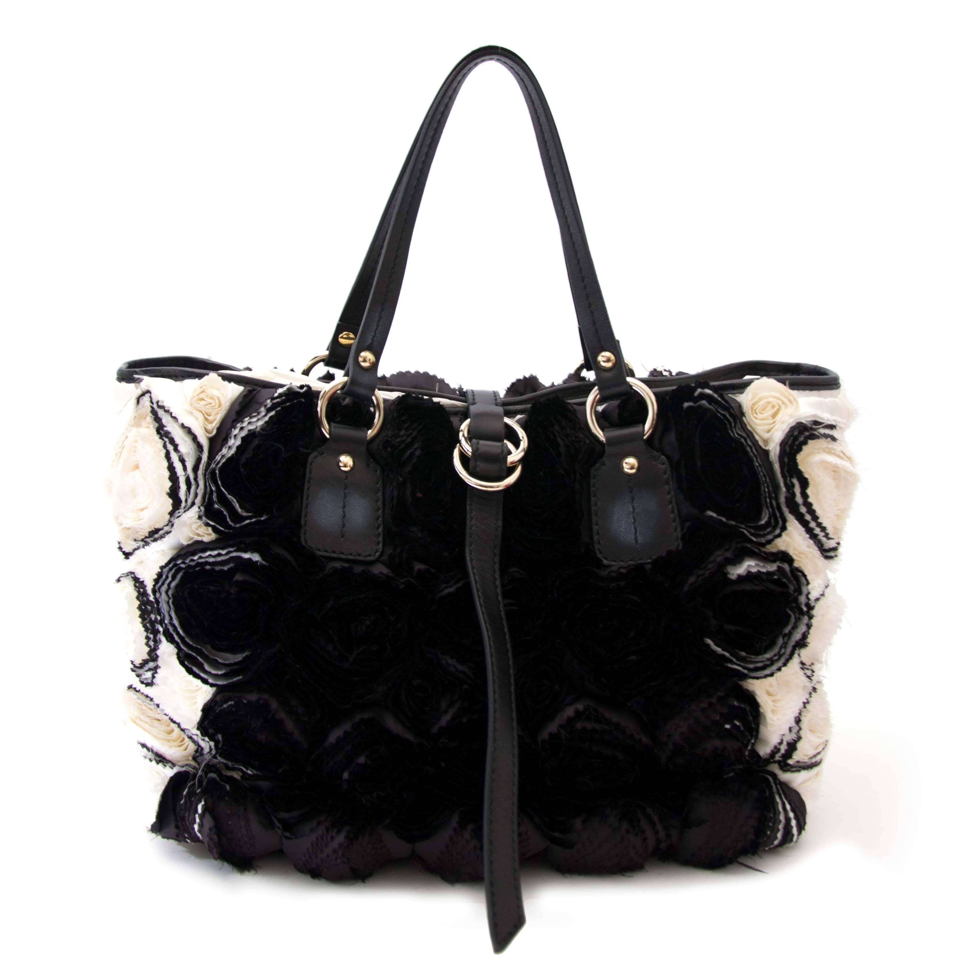 Excellent condition

Valentino Rosette Black and White Shoulder Bag

Turn heads with this distinctive shoulder bag by Valentino. The satin Rosette embellishments make this a one-of-a-kind item. 

Leather shoulder straps, silver toned hardware, gold