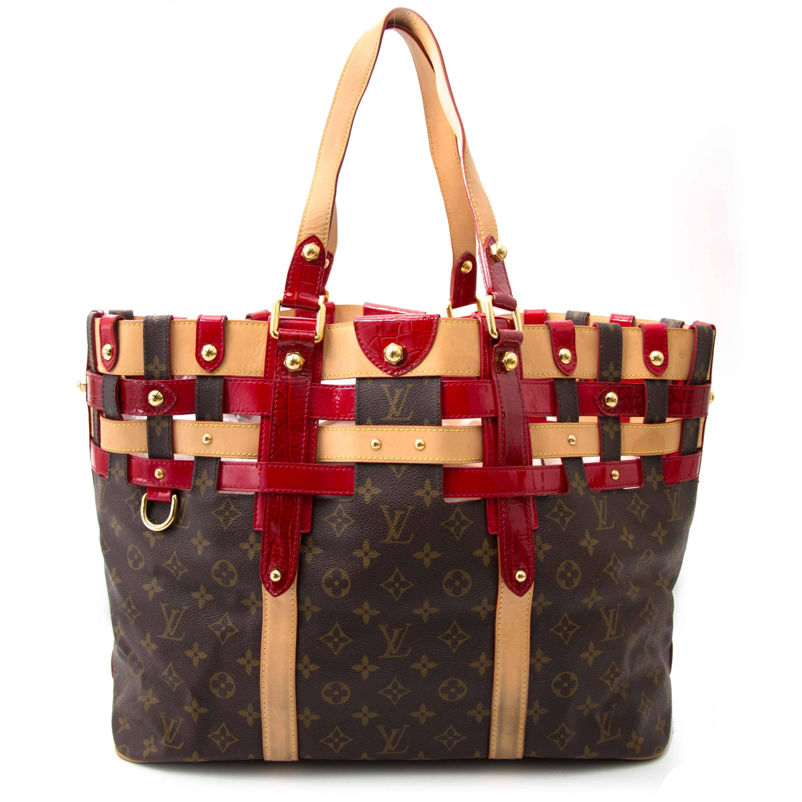 Limited Edition Louis Vuitton monogram Rubis Salina tote bag in GM. The exclusive tote features vachetta cowhide leather top handles and trim with ruby red patent leather and crocodile detailing. The top is open to a matching red fabric interior