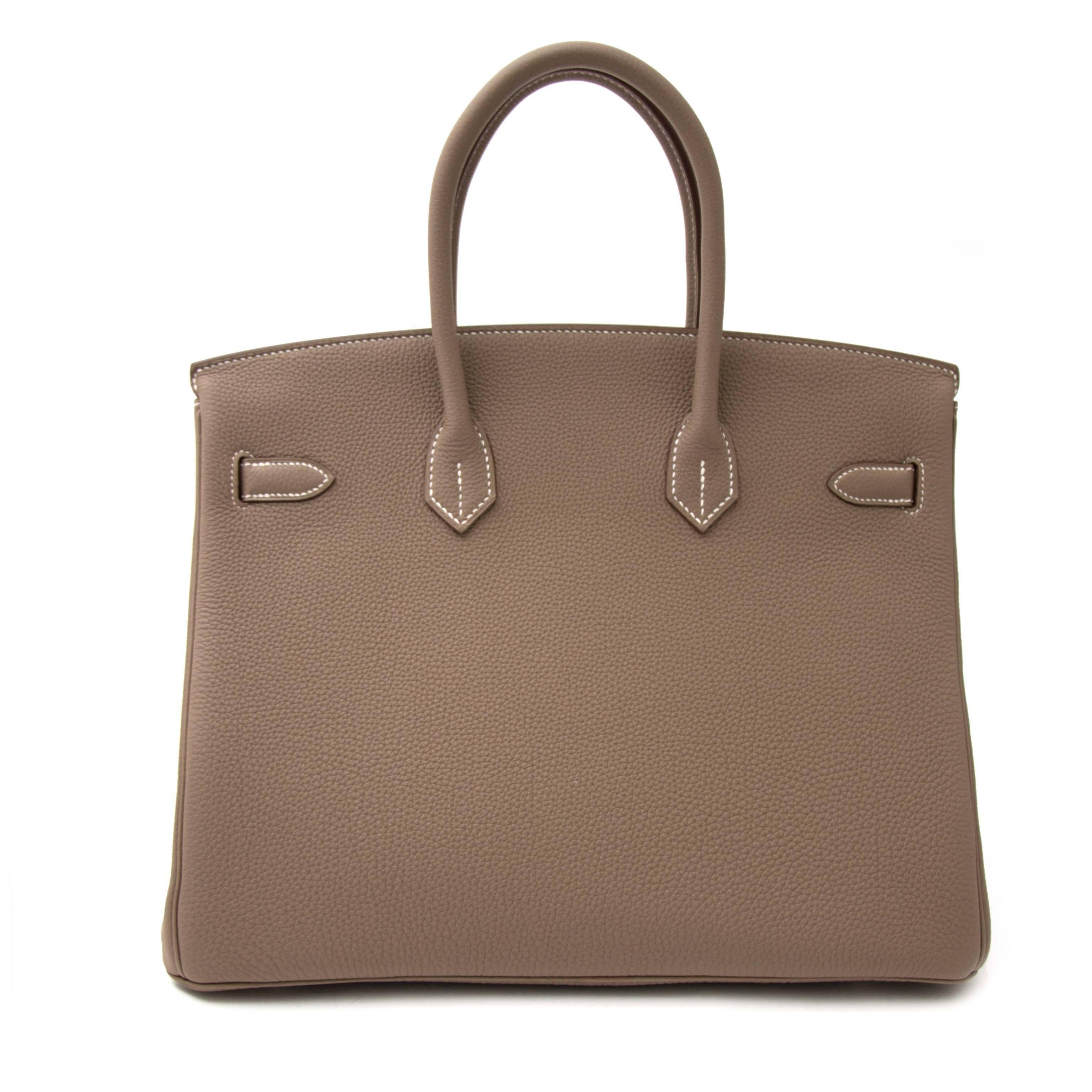 Skip the waiting list and get your hands on one of the most wanted bags of the century: the Hermes Birkin. This gorgeous top handle bag is crafted from fine Togo leather and comes in a perfect neutral Etoupe. The palladium hardware adds a certain