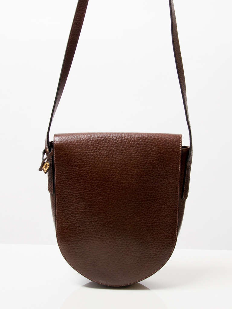 Delvaux brown leather shoulder bag with gold hardware. Adjustable strap. Can also be worn cross body. Magnetic button as closure. 

Comes with the original dust bag.