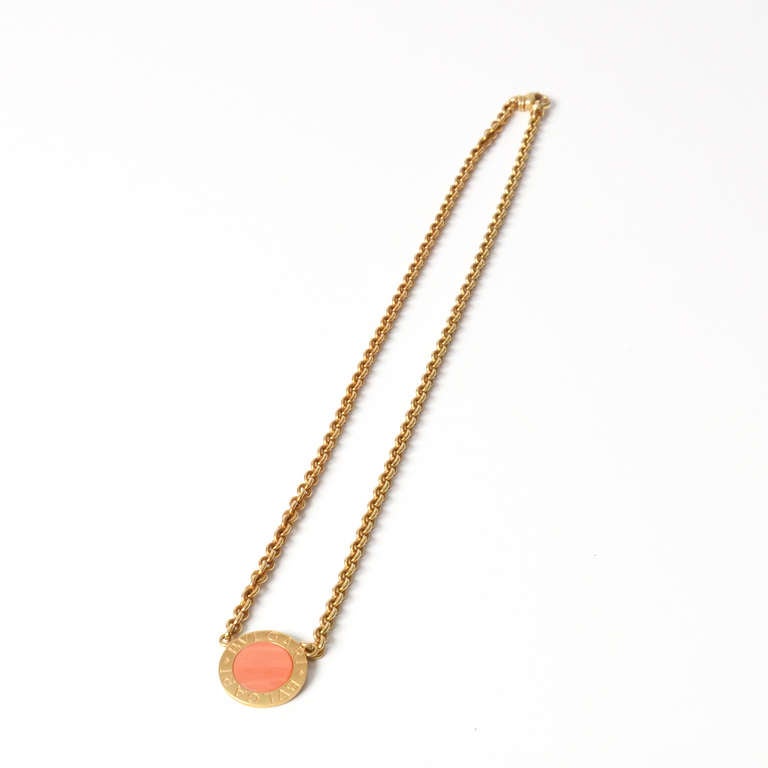 Bulgari golden necklace with coral circle pendant. Only one length possible.