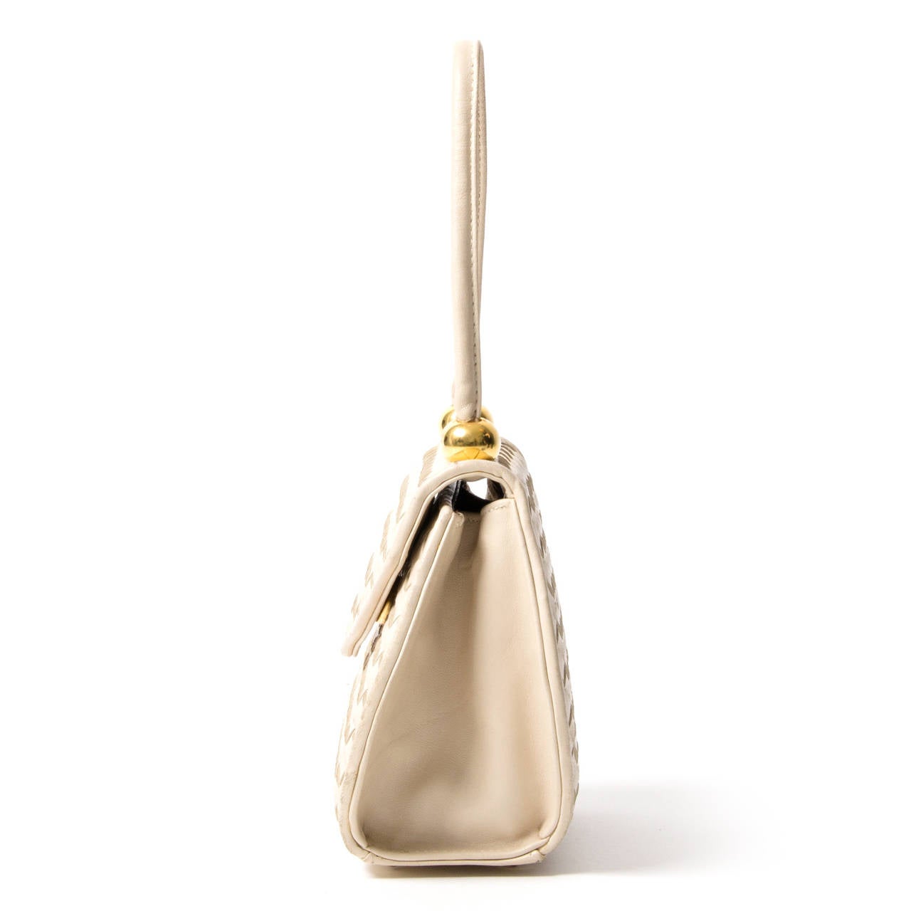 This very small bag comes in cream woven leather with gold colored hardware. The flexible top handle makes this cute number a casual chic style bag, perfect for those who don't carry around much. Four studs on the bottom protect the leather of the
