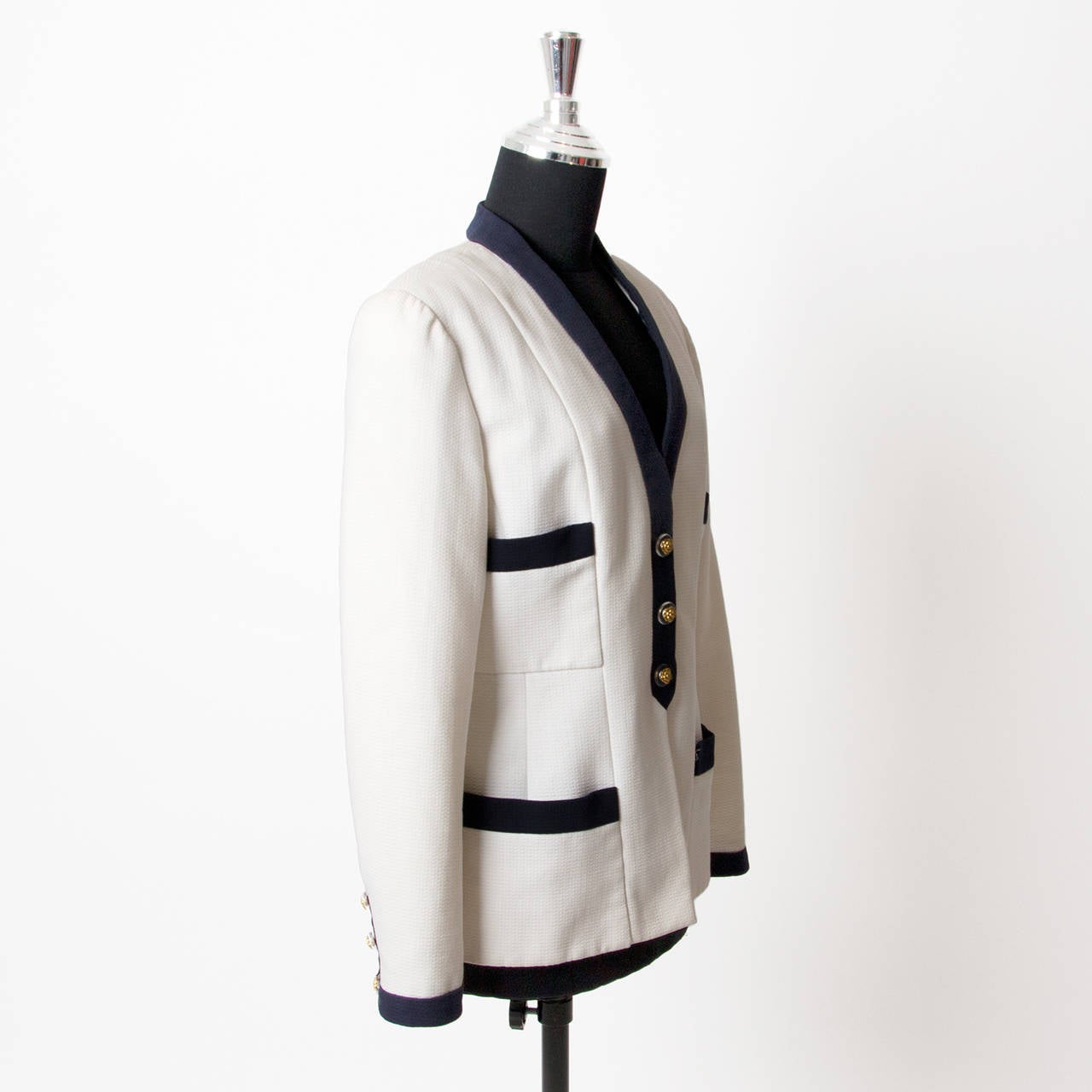 Beautiful Chanel White blazer with blue details. 3 buttons with gold camelia on the front and on the sleeves. A Chanel jacket is a timeless classic! The jacket has been dry-cleaned