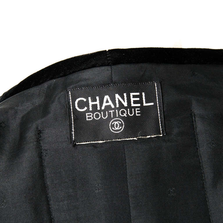 Chanel Black Long Vest with gold flower buttons and velvet lining. One breast pocket and lower pocket on each side. No closure.
