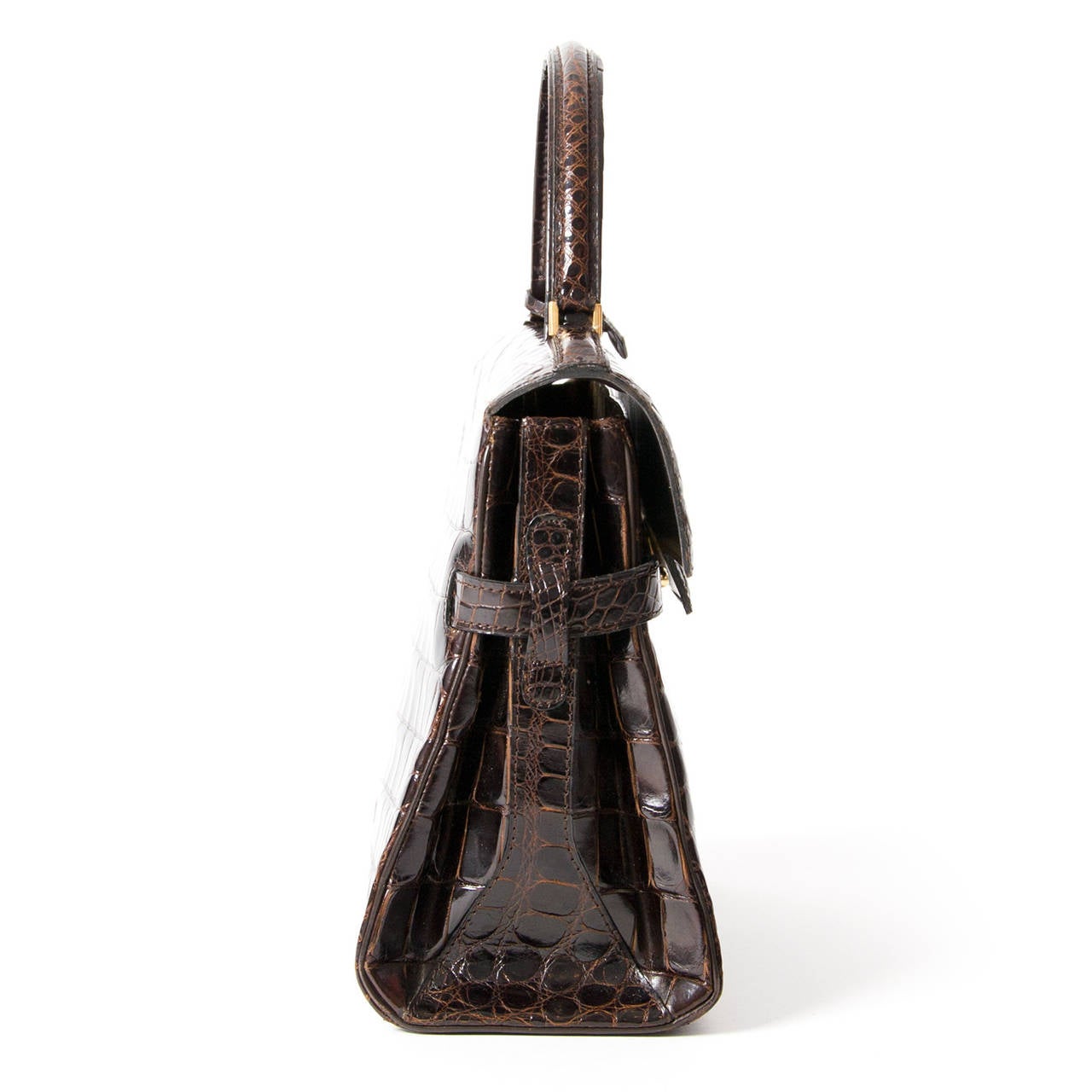 Delvaux Tempête in beautiful dark brown crocodile leather. With its statement hardware and geometric shape, this beauty is one of Delvaux's most architectural bags. Handcrafted out of the finest crocodile leather , this Tempete crocodile edition is