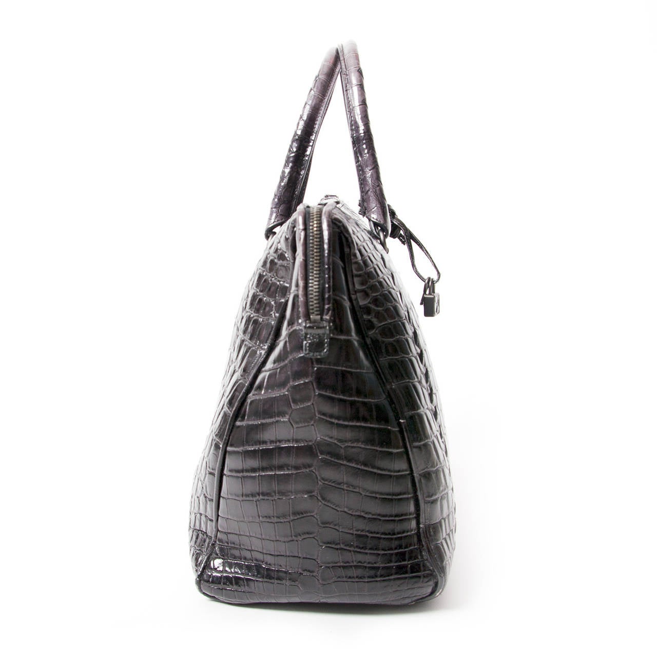 Bottega Veneta black and grey tote bag in beautiful hand-treated glossy crocodile skin.

The charm of this tote is all about the astounding depth of color in the crocodile. Soft grey highlights the large scales in the middle of the bag and those