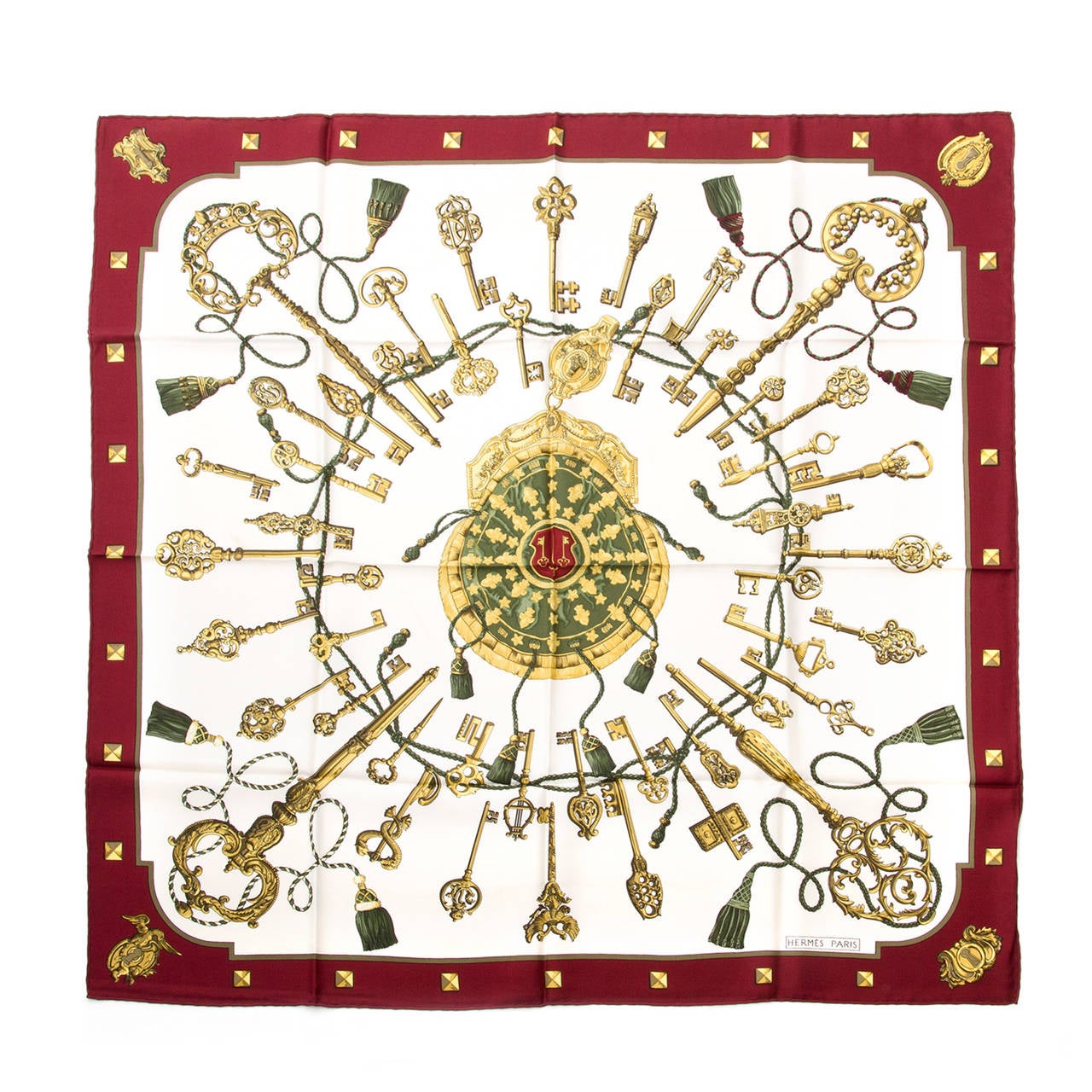 This Hermès scarf is made out of 100% silk. Printed with keys in cream, burgundy and gold.