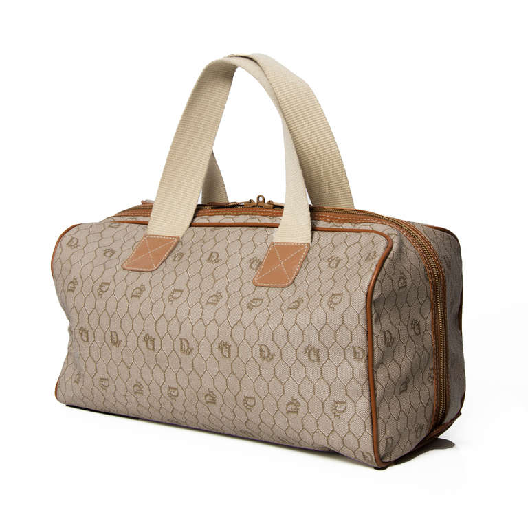 Dior Monogram Duffel Bag in Beige with zipper closure. The interior features a zipper pocket and an open pocket.