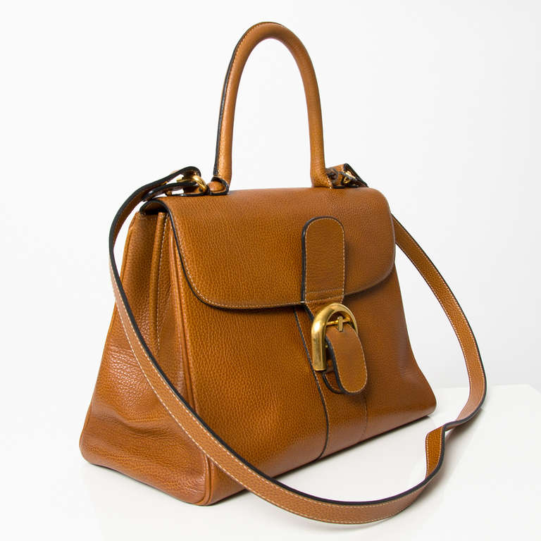 Delvaux cognac colored Brillant MM with attachable shoulder strap. Gold tone hardware. Distinctive buckle at the front. Leather 