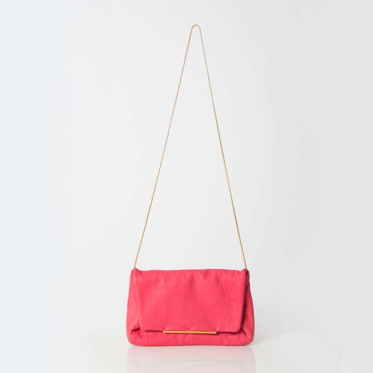 Cute pink neon clutch bag by Lanvin in soft lambskin with a chain link shoulder strap and a snap button closure. 

Dimensions:

Width: 9.5