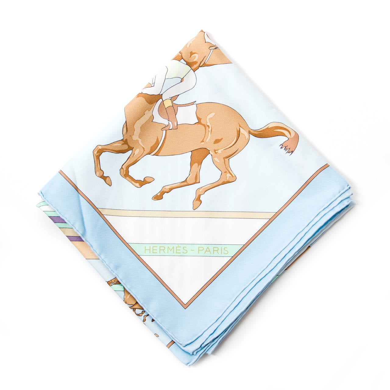 Light blue Hermès scarf in 100% silk. Scarf features image of horse races and colorful stripes.
