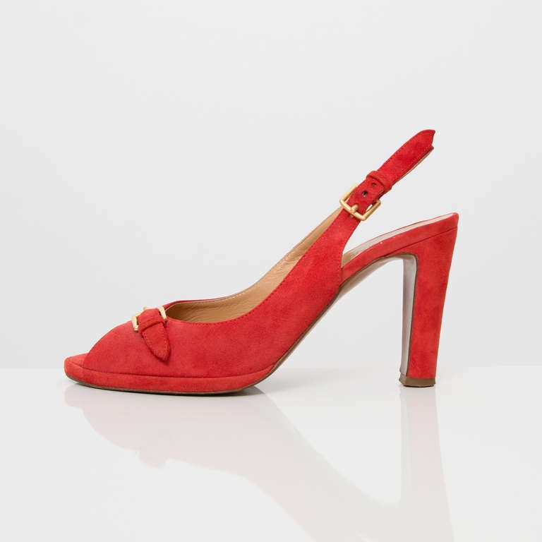 Hermès Paris Peep-toe Pumps in vibrant red suede. The red color is more a coral red, than a tomato red. With yellow gold-tone buckles.