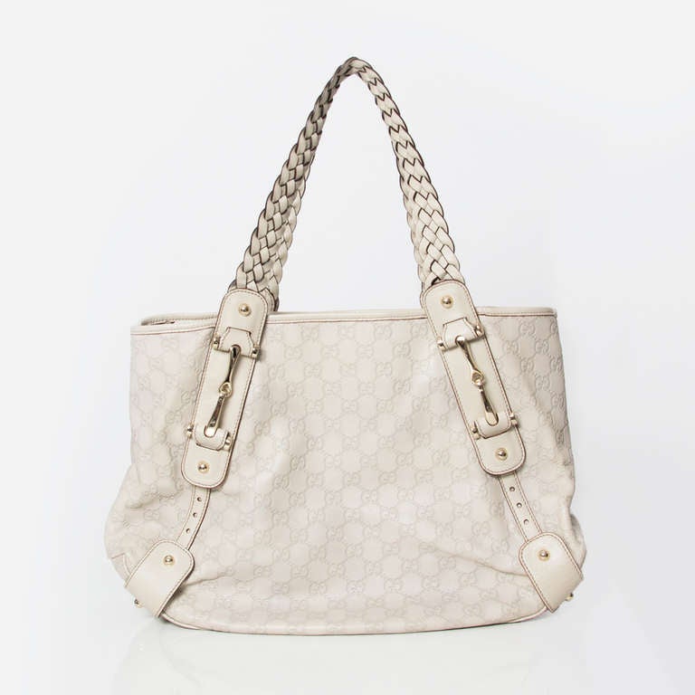 Gucci Bag with matching wallet and key-holder. 
Woven leather shoulder straps. 
Embossed monogram exterior. 
Color: dark cream color or  'ecru'. 
Comes in original dustbag. 

Dimensions: 44 x 30 x 14 
Handle drop : 23cm