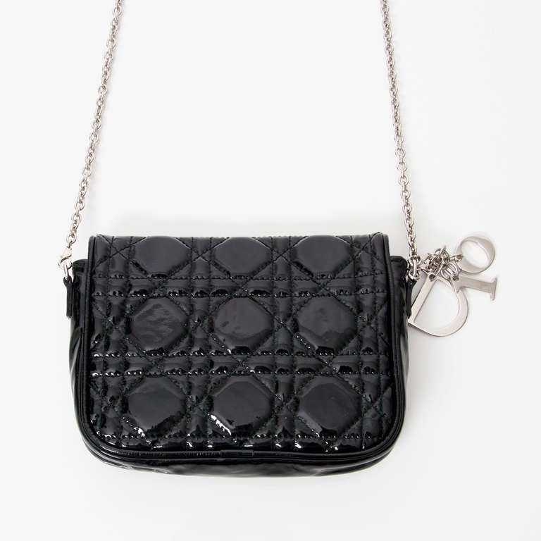 Dior 'Lady Dior' Patent Black Pochette Clutch. With siver-tone hardware. 
Stamped: 'Made in Italy 02- LU - 0079'

Interior lining: lambskin. 
Exterior: quilted patent vinyl. 

Handle drop: 57cm