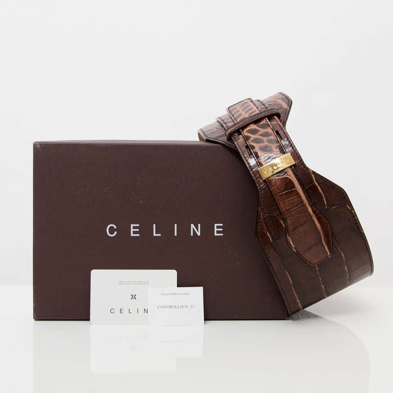 Wide waist belt with goldtone hardware by Céline Paris. 
Exterior dark brown croc embossed leather. Interior suede calfskin. 
Size 'M', fits EU 36 to 38.