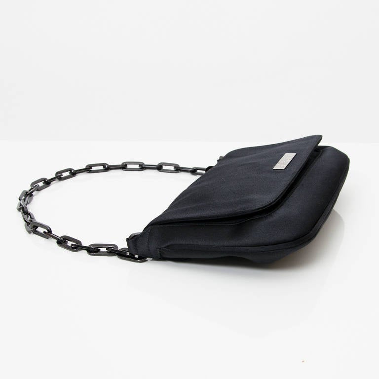 Gucci black mini flapbag with chain handle and magnetic closure. One inside zipper closure.