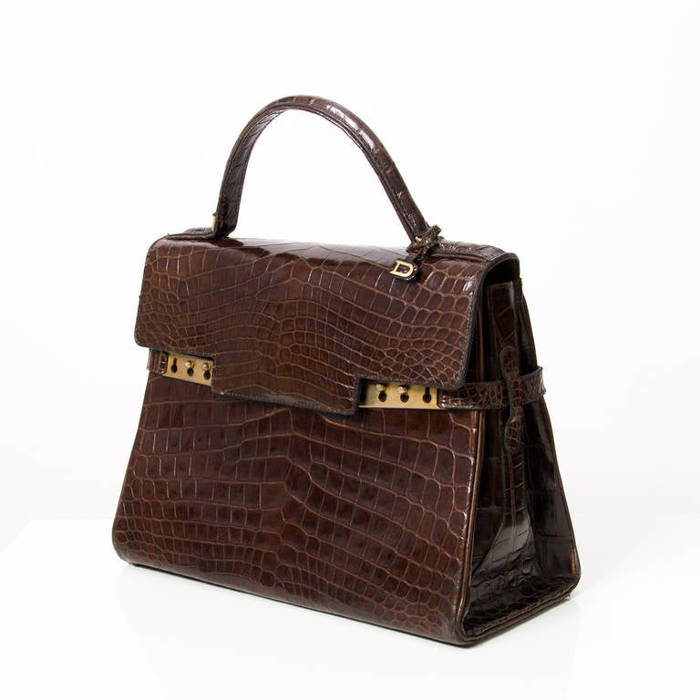 Stunning Large Tempete by Delvaux in brown crocodile. Classic structured bag. Good vintage condition, with some minor signs of wear. Gold brushed hardware. Comes with authenticy certificate from Delvaux Brussels and dustbag.