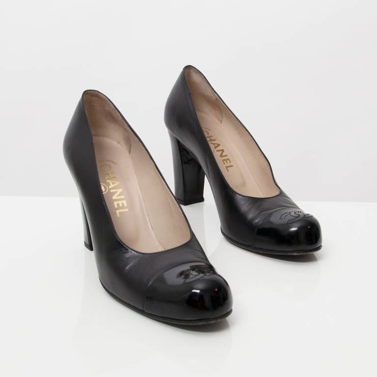 Chanel is the epitome of class and style. Cap toes will be all the rage come this fall. Featuring an understated yet chic, elegant black leather pumps will easily take you from day to night.