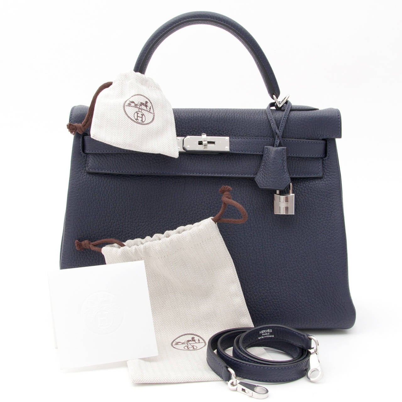 Brand new, storebought Hermès Kelly bag 32 in beautiful 'Blue Nuit' or midnight blue - a deep, rich dark blue hue - in Taurillon Clemence leather. 
Has paladium hardware and comes with clochet cadenas keyholder and padlock. 
Blindstamp 'T' ,