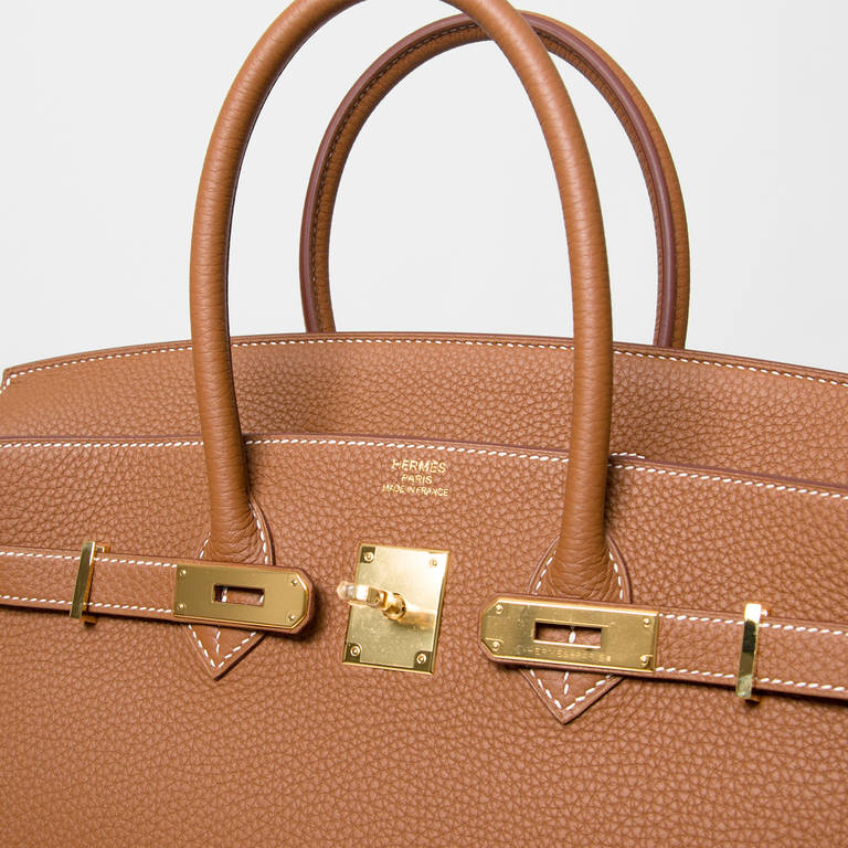 Hermès Birkin bag. 

Leather type: Togo, scratch resistant calf leather. It is textured with a wonderful grainy appearance.  Togo is soft to the hand and maintains the shape of the bag well over time.

Color 'Gold'. 
Gold hardware. 
Blindstamp
