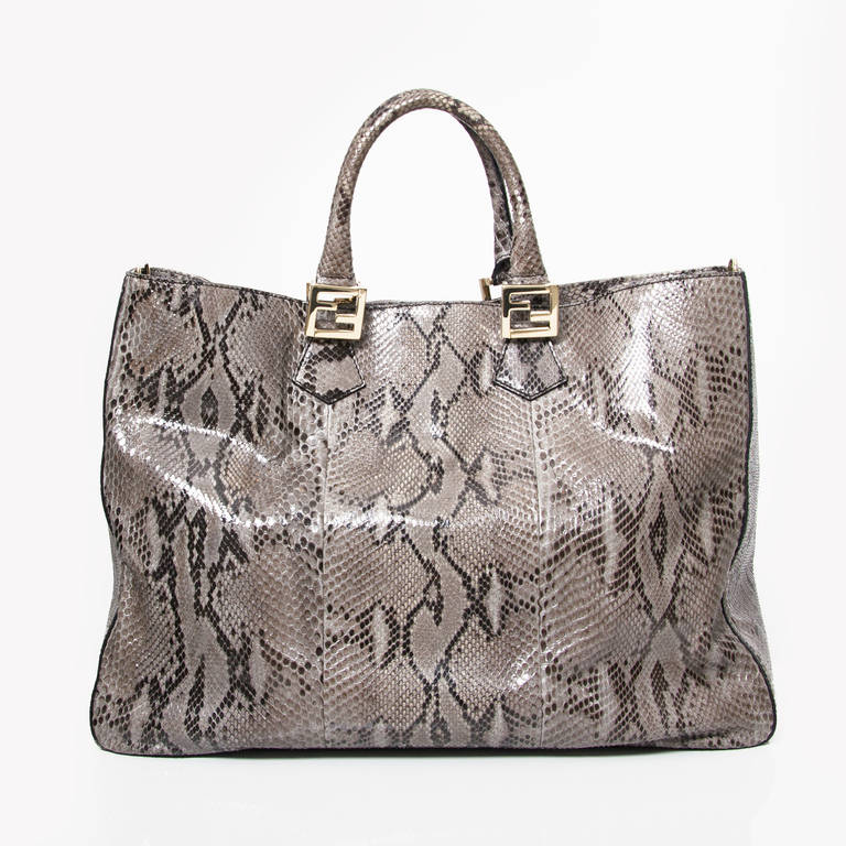 FENDI Python Twins Tote Natural. The unique style of this Fendi tote create a chic and unforgettable look for day. Beautifully crafted of natural python skin. The bag features thin reinforced python top handles and golden hardware including