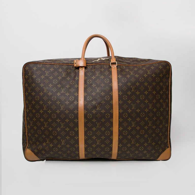 Louis Vuitton Vintage monogram luggage with double zipper. 
Features a Leather ID holder.