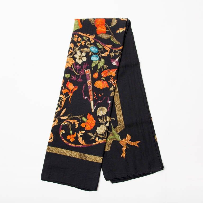 Large 35% silk and 65% cashmere blend scarf by Herùès, titled 'Pierre D'Orient Et D'Occident', signed 'Zoé'. 
Black backdrop with vibrant orange and purple hues. Perfect large and warm scarf for Fall.
