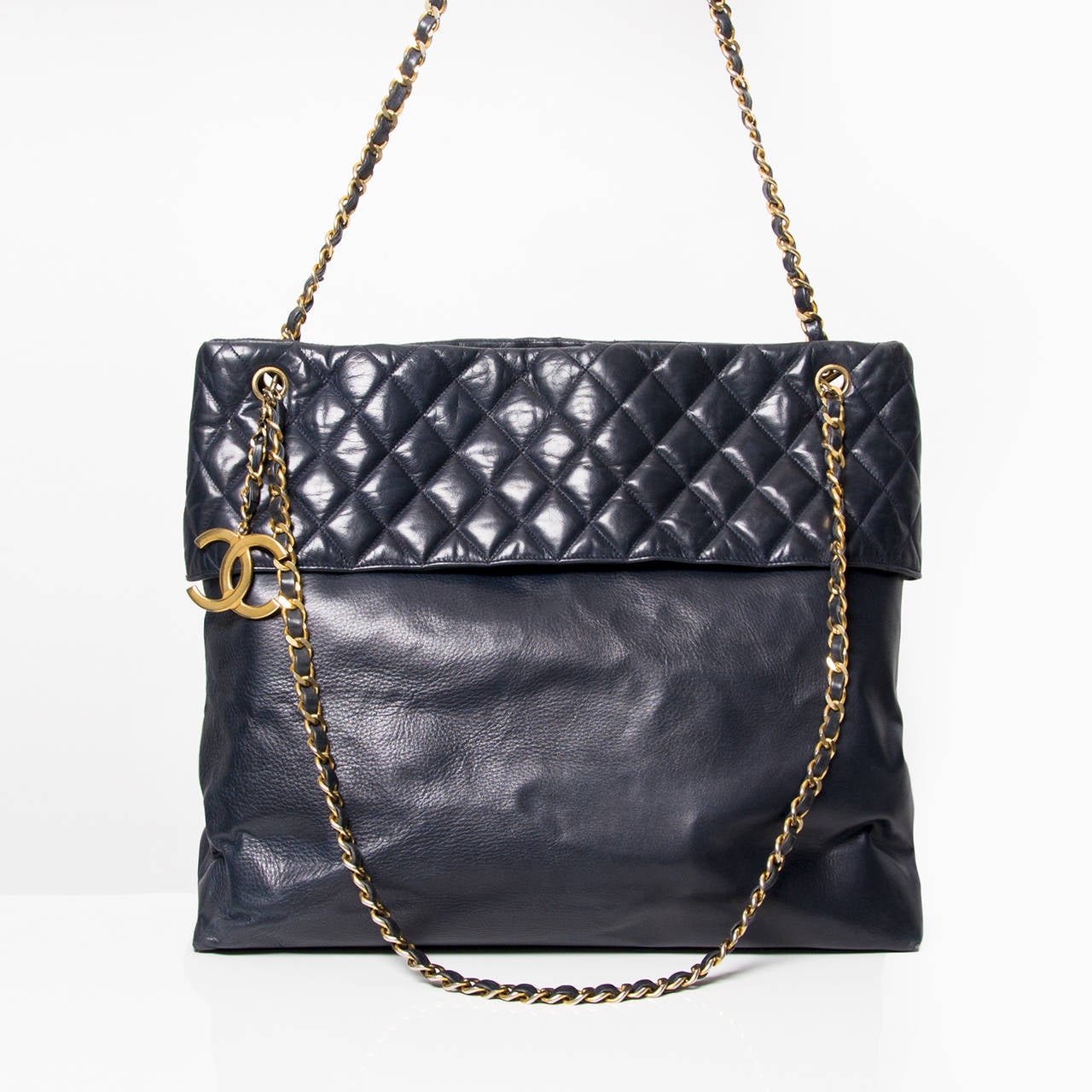 Chanel vintage dark blue Tote bag with golden hardware. 
Magnetic closure. 
One inside zipper pocket.