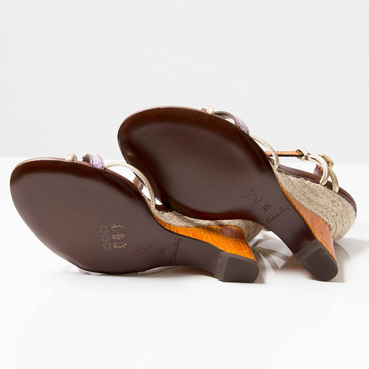 Louis Vuitton purple and orange leather Louis Vuitton wedge sandals with gold-tone and side buckle closure.