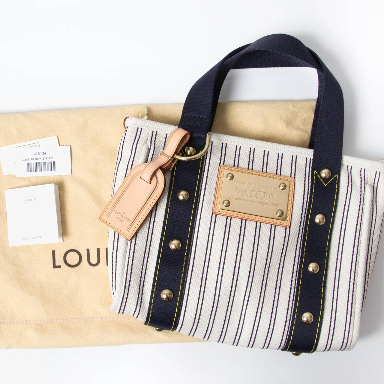 Louis Vuitton Toile Canvas Antigua Cabas PM Bag. 
Striped canvas or 'Toile Antigua'. With gold embossed plate on the front, tan cowhide trims and textile lining. 

Comes with original production serial code 'M40134' and 'Toile Textile' booklet.