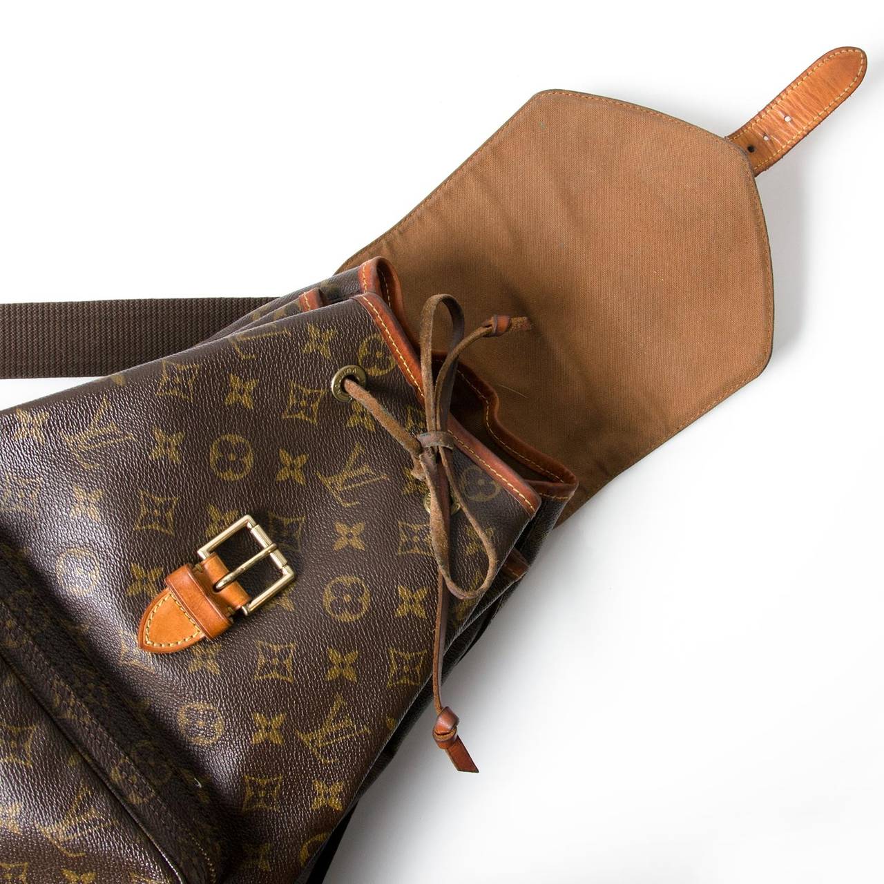 Made by the iconic French brand, the vintage Louis Vuitton bag is a throw over the shoulder style backpack; both practical and chic. Crafted from high quality leather, the brown and camel coloured, monogrammed canvas is filled with signature 'LV'