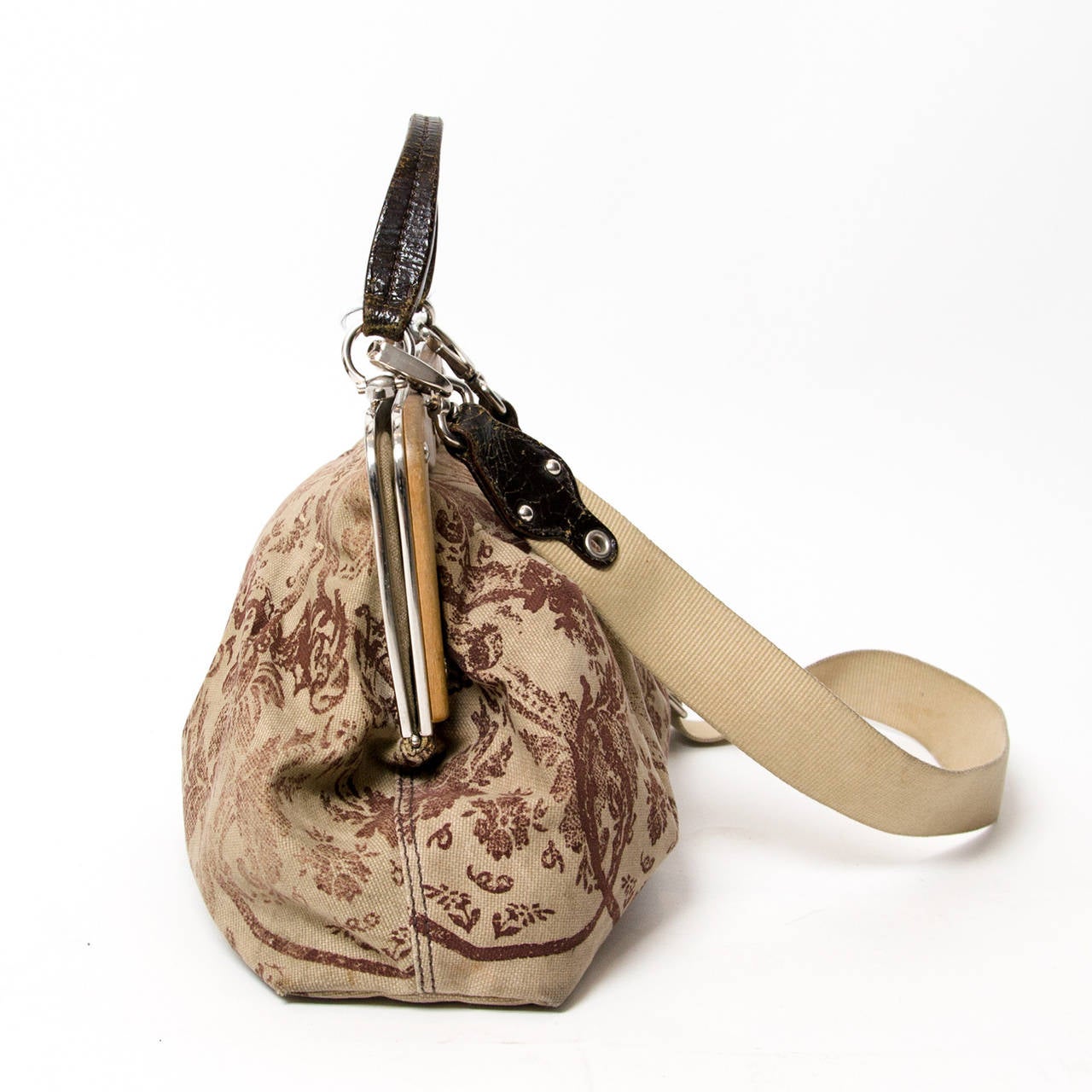 Miu Miu canvas floral top handle bag with wood details.