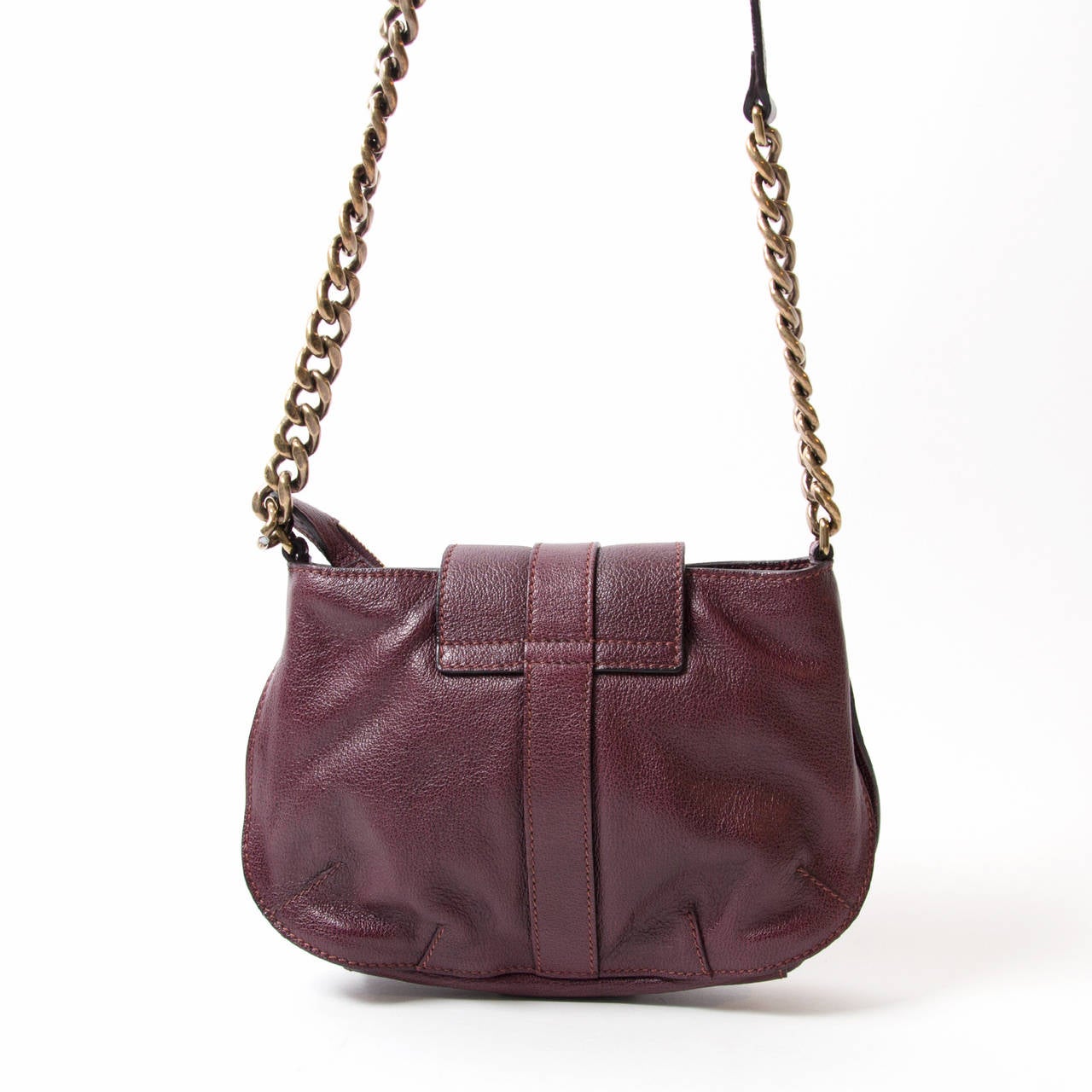 Buffalo Leather Shoulder Bag - Plum. Plum buffalo leather with aged brass hardware. Zip-top and leather belt with Burberry engraved turn-lock closure. Adjustable chain/leather shoulder strap. Black novacheck lining with zippered pocket and two open