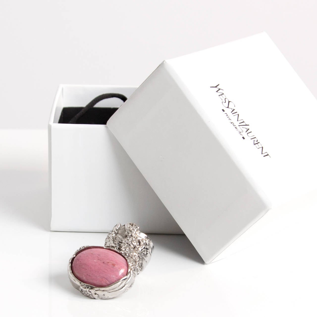 Arty Silver and pink glass ring. 
Yves Saint Laurent reworks its covetable 'Arty' ring with a fresh-hued pink glass stone. Wear it with a boldly printed shirt for a glamorous daytime combination.
size 6