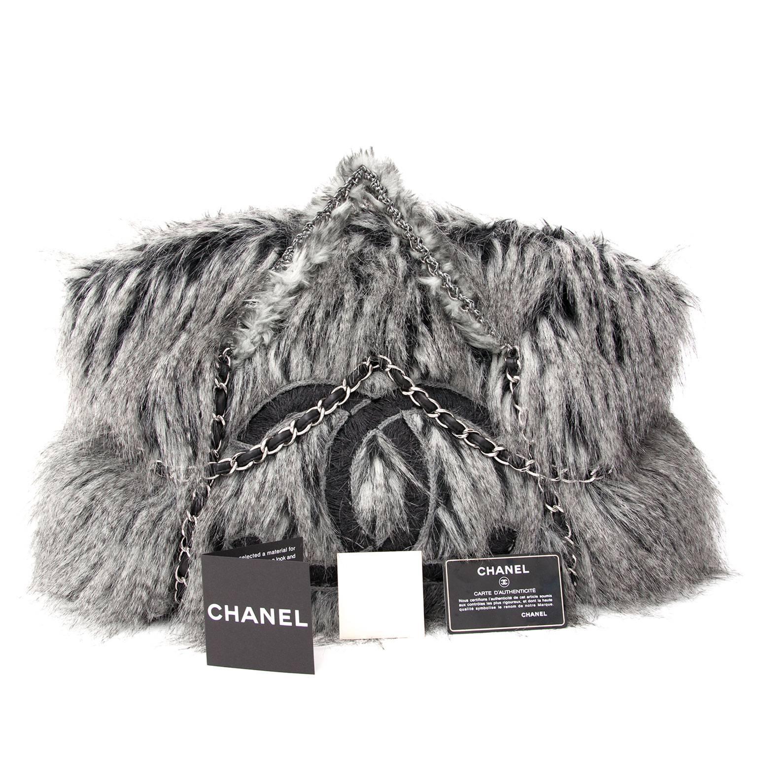 Limited Chanel Grey Faux Fur Arctic Fantasy Fur Large Tote Bag.
This unique tote bag runway 2010 is extremely hard to find and features a grey faux fur with a silver chain and leather detailing throughout. The Perfect bag for the die-hard Chanel