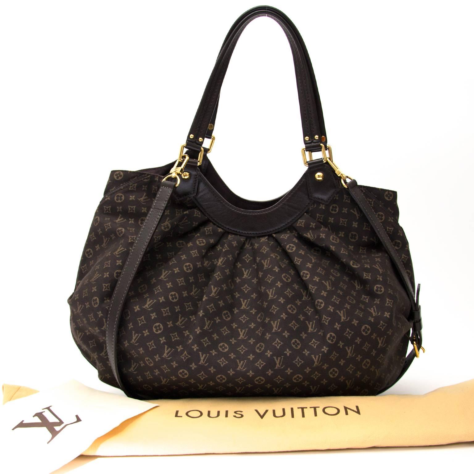Louis Vuitton Monogram Fantaisie bag with complimenting tall shoulder straps in black leather. The spacious and practical interior is accessed through gold-toned magnetic press button and contains three slip pockets, from which one with zipper. The