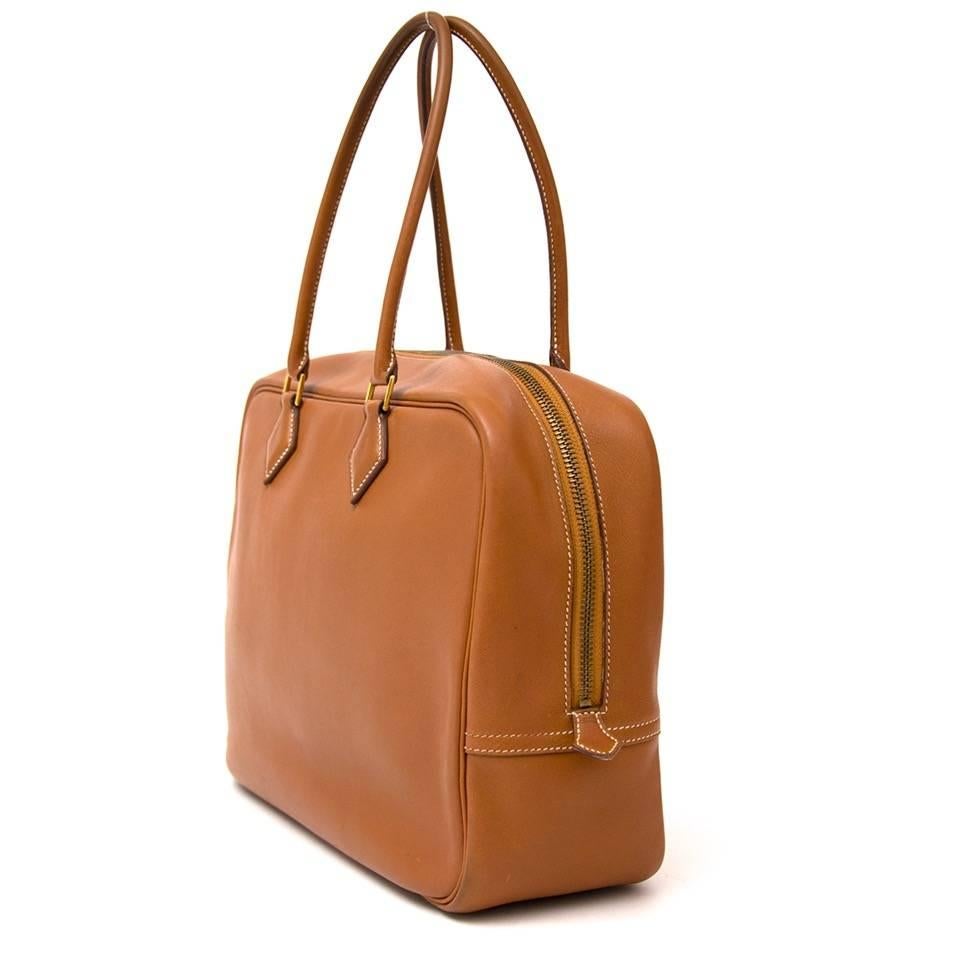 Upgrade your office look with the Hermes Plume Bag in cognac leather. The simple, but classy design features a zip opening and a wide and practical interior with three slip pockets. Gold-toned Hermes stamp on the inside. 
