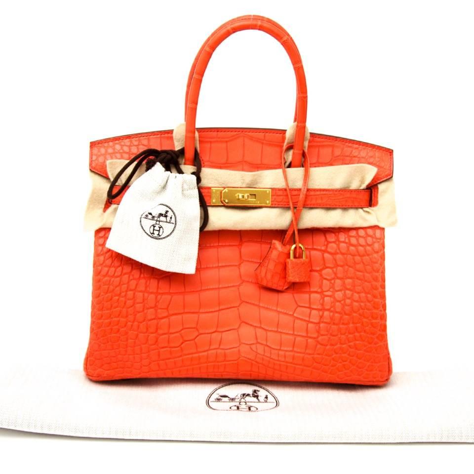 The height of luxury in its purest form, this Hermès Birkin 30 Alligator in the coveted color Orange Poppy is a true showstopper. Gold hardware. Brand new, straight from the store. Full set.
Plastic still on the hardware, receipt and cites