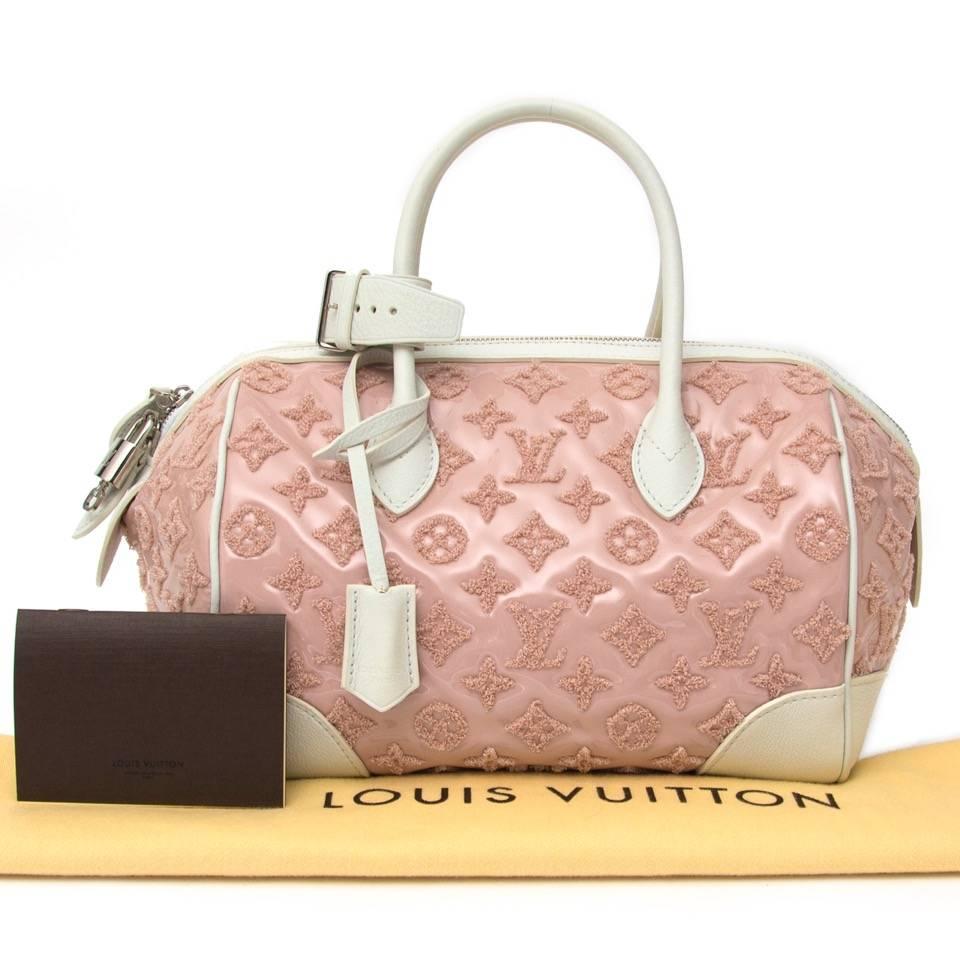 Limited edition ** Louis Vuitton Pink Bouclettes with lovely fabric monogram logos. The bag is crafted of patent lambskin and finished with white leather trim on the bottom, corners and on top. The silver double zipper comes with a matching