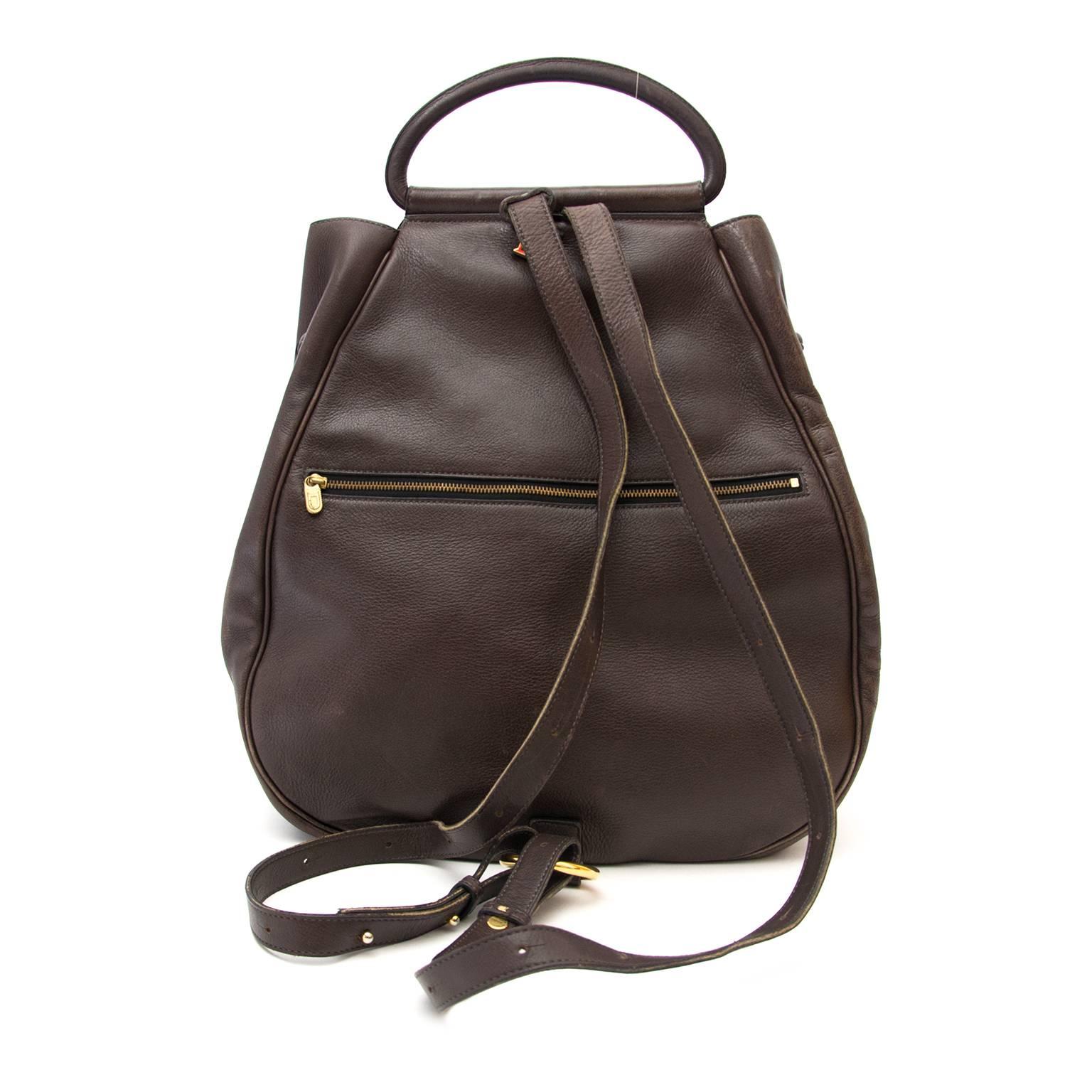 In Good Preloved Condition
Delvaux Brown Cerceau GM Backpack 
This beautiful and iconic backpack from Delvaux is perfect for travelling. This purse has a zipper on the back, gold tone hardware on the front and a keychain clip on the inside. This bag