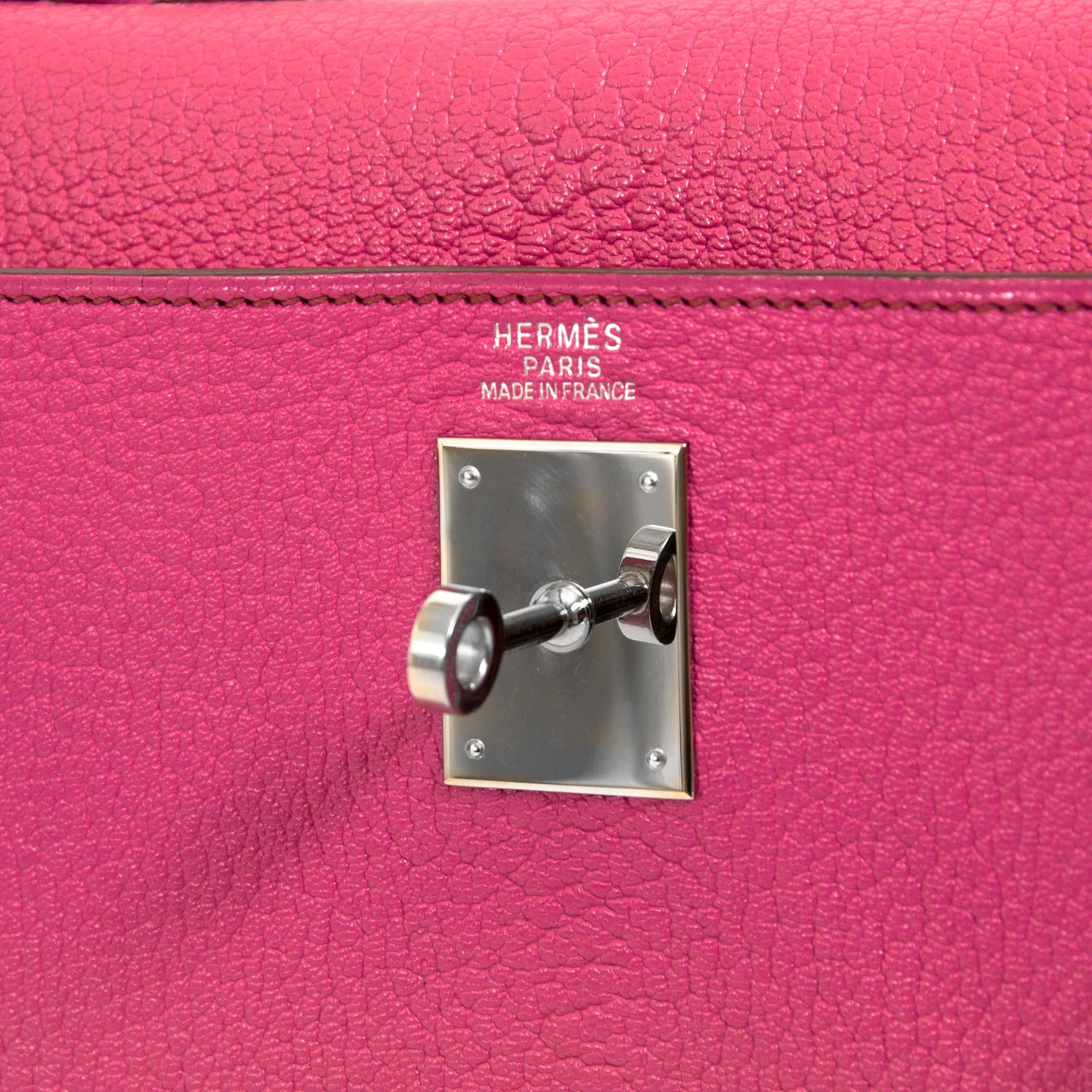 This very rare and exclusive Hermès Kelly 32 Chèvre de Coromandel Sellier Fuchsia PHW features all of the iconic features of the Hermès Kelly bag but with a very modern touch. The bag's features include rolled top handle, detachable shoulder strap,