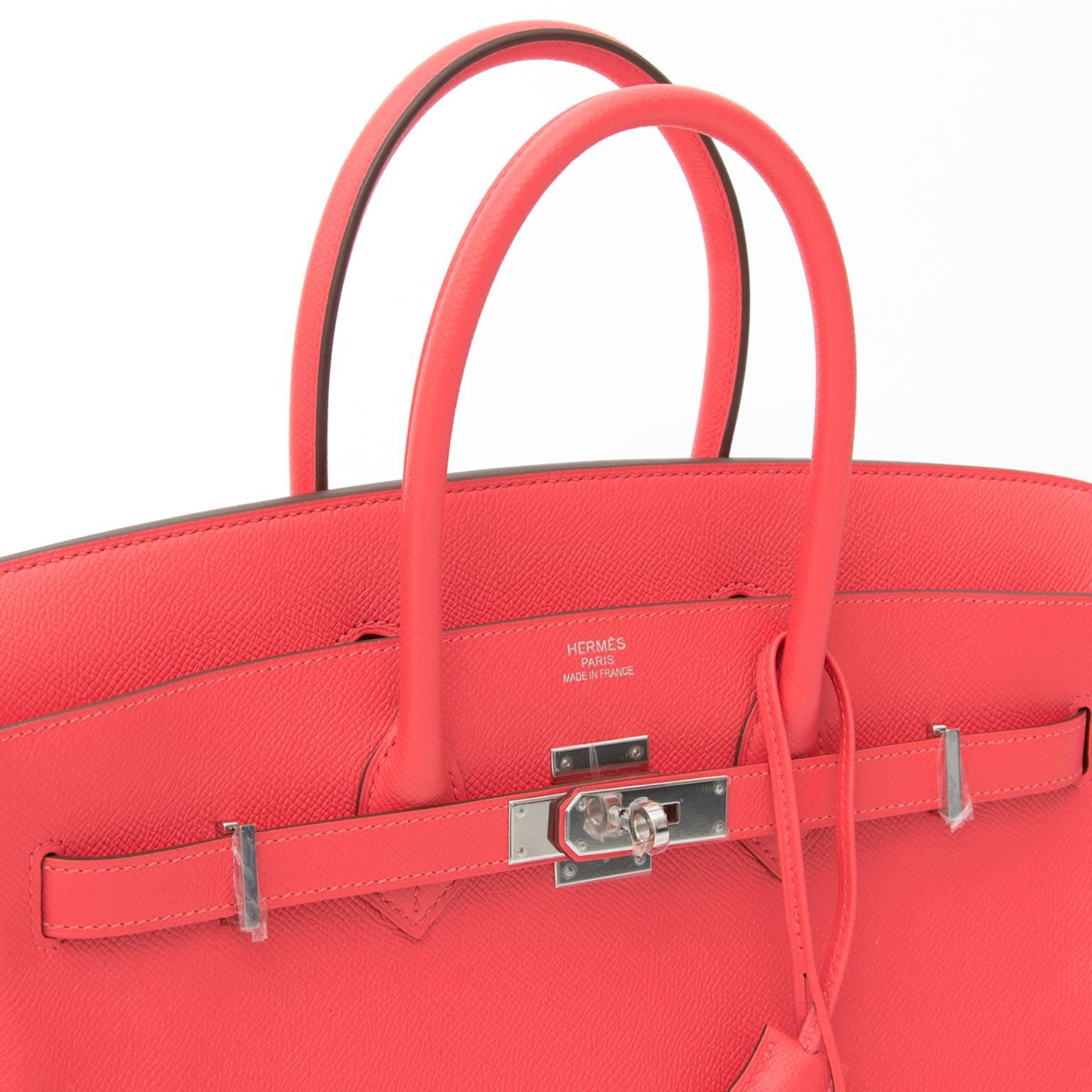 This is a brand new, storebought Hermès bag, handcrafted from Epsom leather, a grained leather type that keeps its upright structure. 
The color is a lively, enchanting pink, Rose Jaipur, named after the famed Inidian city.
The paladium silver-tone