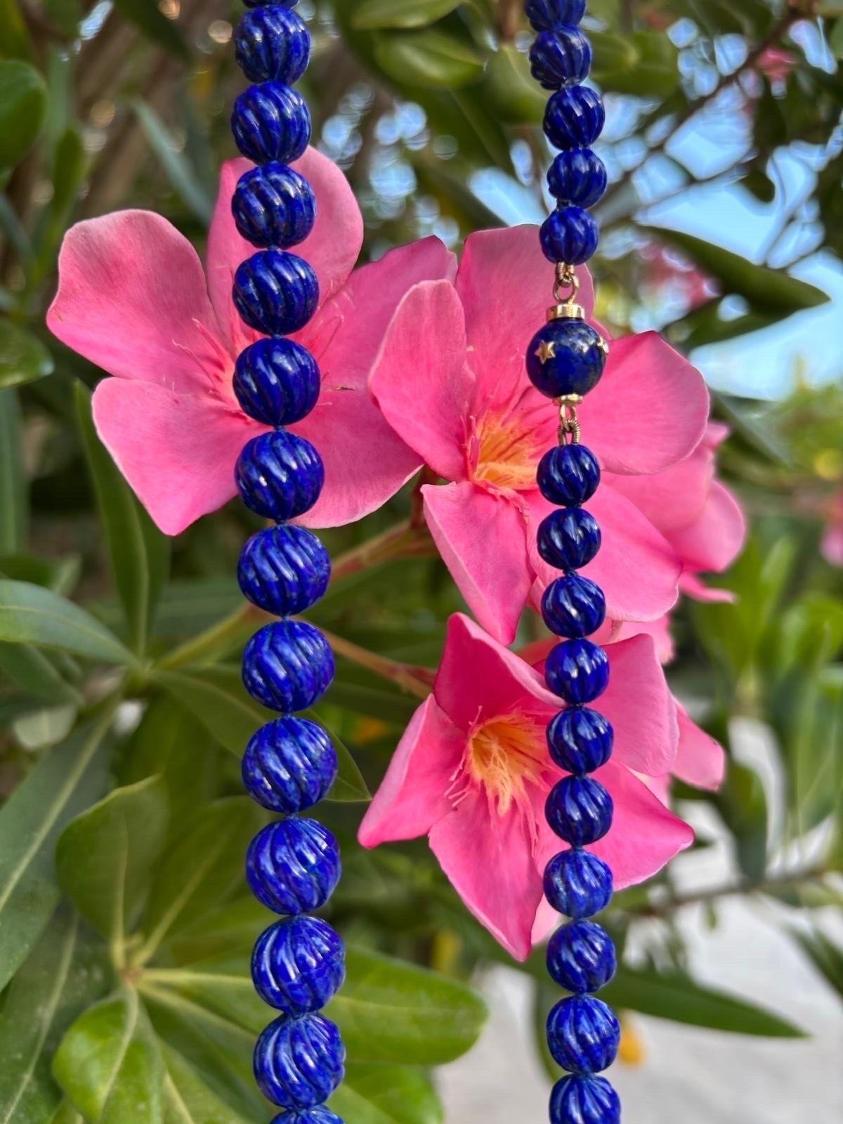 A regal 22 inch giant royal blue Lapis Lazuli necklace with extremely rare and finest quality Lapis in an exceptional large size, chape and very rare enchanting color. The beads are handcarved with a fluted pattern, giving the necklace a playfull