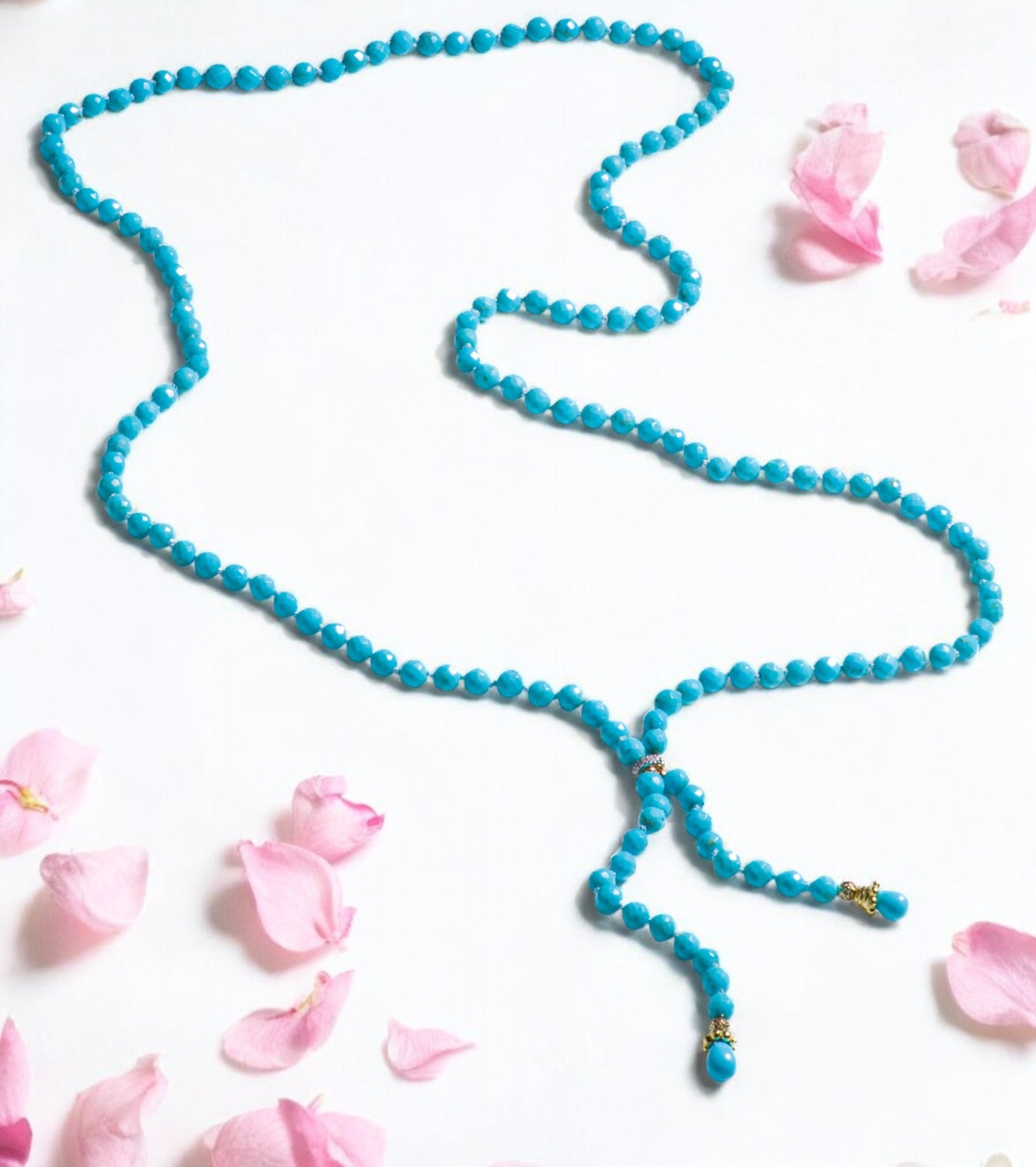 A regal nearly 30 inch long handcrafted necklace with extremely rare handcarved Sleeping Beauty Turquoises. This necklace features genuine high grade Robinson Egg Blue turquoises, delicately strung together with sparkling diamonds, yellow gold