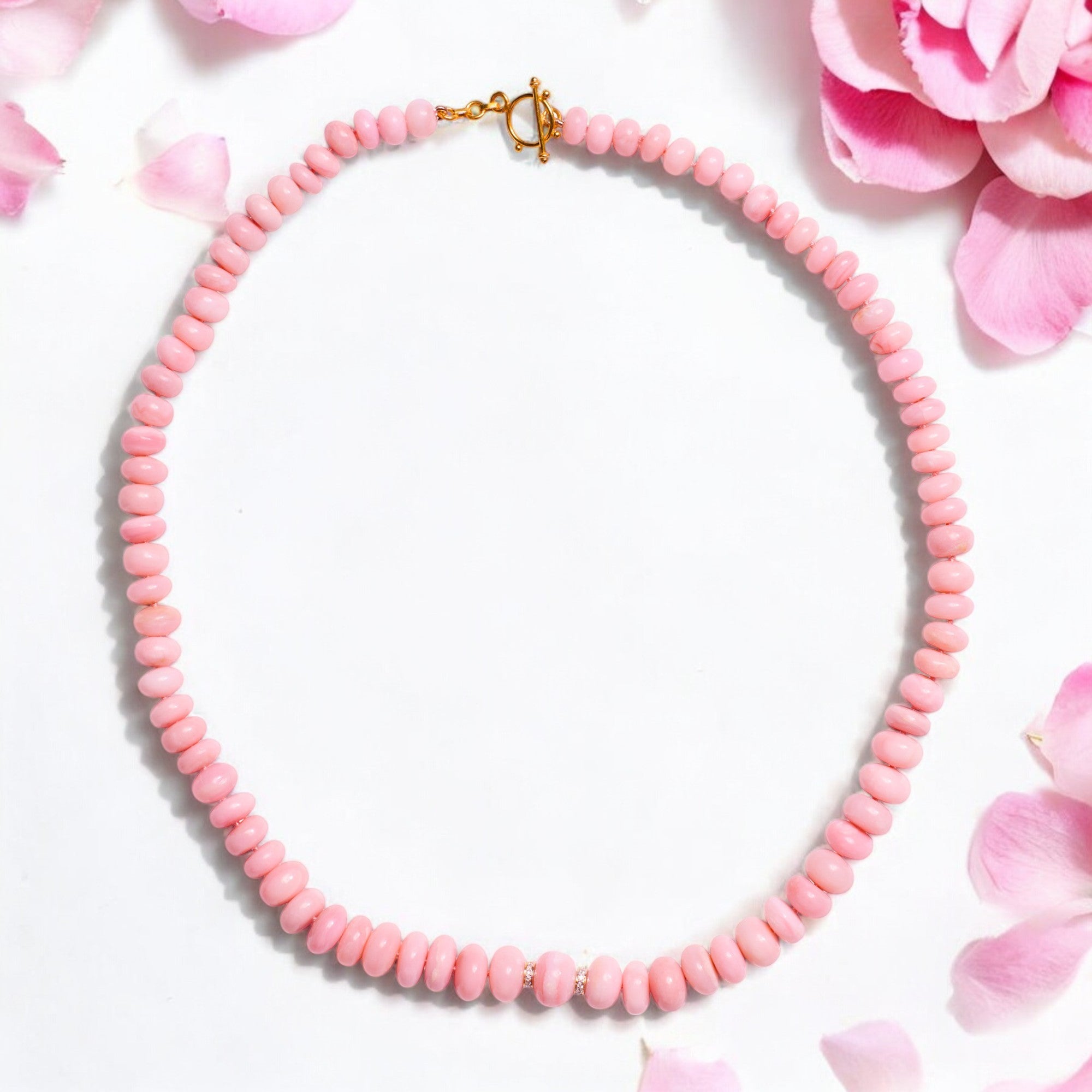 Step into a world of exclusive elegance with this one of a kind blush pink opal necklace, made from the most exclusive and rare pink opals from Peru. 
Featuring a unique gold clasp, sparkling diamonds and the highest grade pink opal beads. This