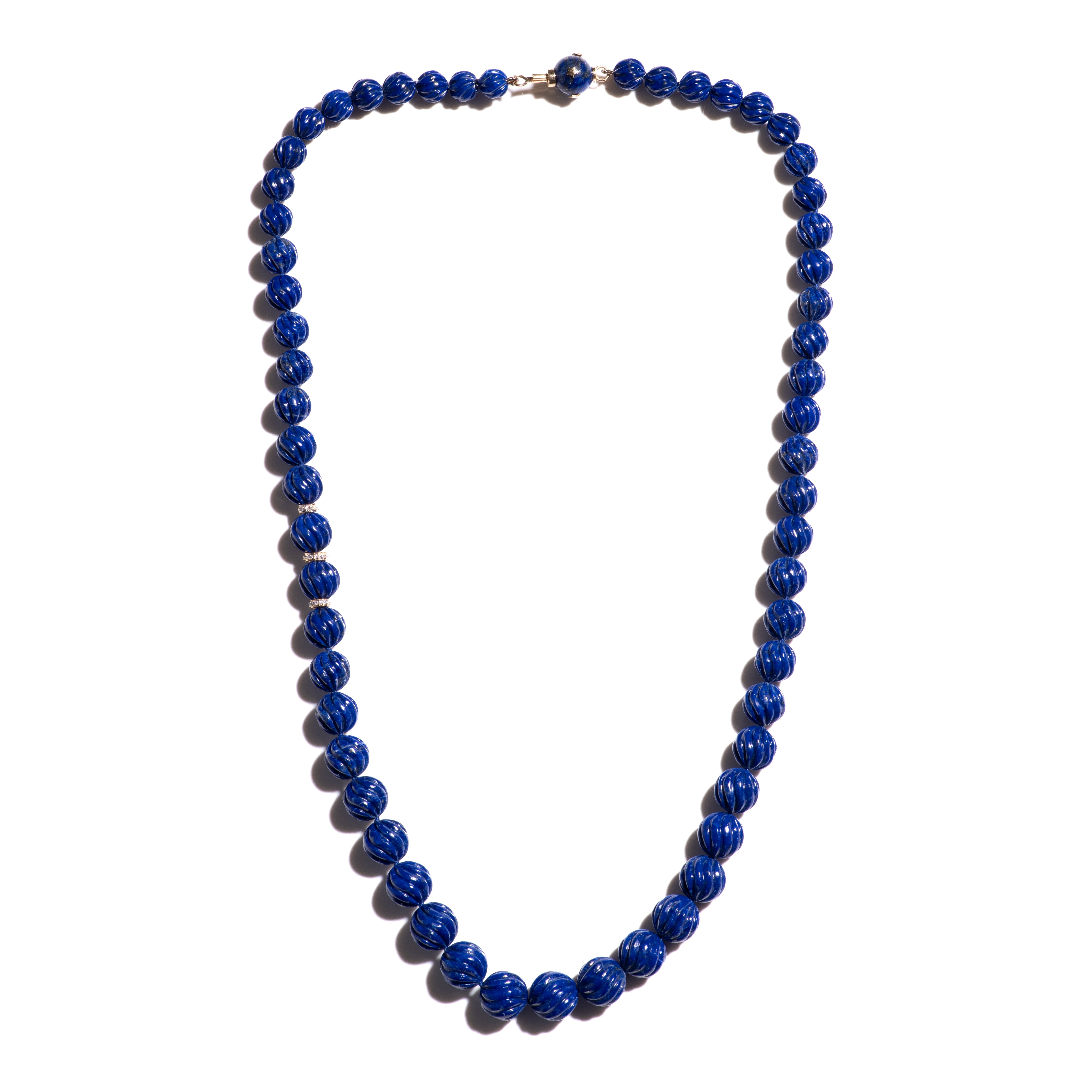 A regal 22 inch giant royal blue Lapis Lazuli necklace with extremely rare and finest quality Lapis in an exceptional large size, chape and very rare enchanting color. The beads are handcarved with a fluted pattern, giving the necklace a playfull